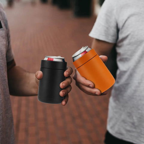 Two people holding cans in Stainless Steel 12oz Vacuum Insulated Can And Bottle Cooler Keeps Ya Drinks Ice Cold With Double Wall Construction Copper Plated Chiller Metal Cooler For Cans And Bottles Black Finish.