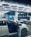 Ultra Bright Led Garage Lights With Hexagonal Grid System illuminating large garage with open vehicles visible