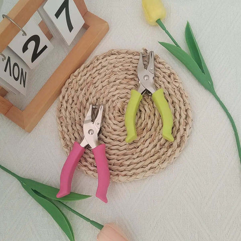 Soft Grip Hole Punch Set with pink and green handles displayed on a woven mat, featuring 1/4 inch and 1/8 inch sizes for scrapbooks.