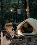Survival Prepper Grade Fire Starter Kit With Handmade Wooden Handle Ferro Rod Three Eighths Inch Thick Striker in hand at campsite