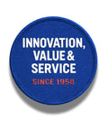 Blue circular patch with text 'Innovation, Value & Service Since 1958' embroidered in white and red.
