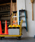 Knockout Performance P Touch Pro Label Maker Equipped With One Touch Keys For Printing Rock Solid Laminated Labels On Electrical Panels Cable Spools Workshop Drawers And Garage Shelves with orange cones, yellow hard hats, and ladders.