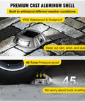 Close-up of Solar LED Driveway Lights 16 Pack With Switch Waterproof with a car tire showing pressure-proof capability.