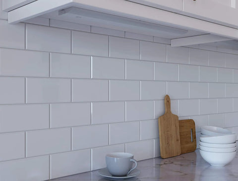 Kitchen setting with 24 Inch LED Under Cabinet Light Bar No Fuss Direct Wire Dimmable and Linkable Super Bright Kitchen Counter Lighting 895 Lumens 3021K Warm White 50,000 Hour Lamp Life White Finish installed under cabinet, highlighting backsplash.