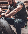Man using motorbike, 6-Pc Aluminum 1/4 Inch Hex Shank Screwdriver Bits Holder Kit clipped to jeans, visible carabiner, DIY setup