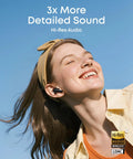 Smiling person wearing Adaptive Noise Cancelling Wireless Earbuds With Real Time Translation And Hi Res LDAC Audio outdoors