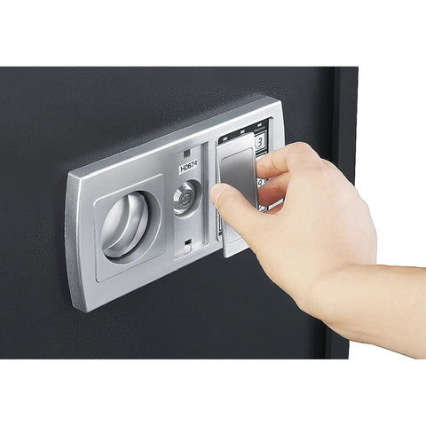 Hand using digital keypad on Compact Steel Home Safe Box With Digital Keypad And Two Manual Override Keys Rugged 11 Gauge Construction