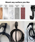 Sturdy Wall Mount EV Charger Holder For SAE J1772 Cables With Locking Hook and Snug Dust Covers mounted on a wall with cables neatly stored.