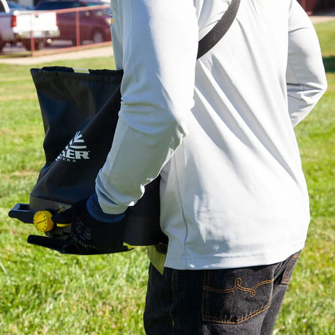 Person using Spyker 25lb Bag Spreader With Material Viewing Window And Easy Calibration System on lawn