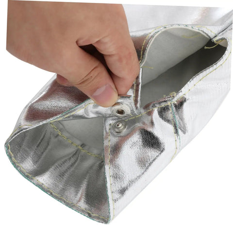 Hand pressing the snap button of Badass Flame Resistant Heat Shield Arm Sleeves For Mechanics with flexible aluminum foil.