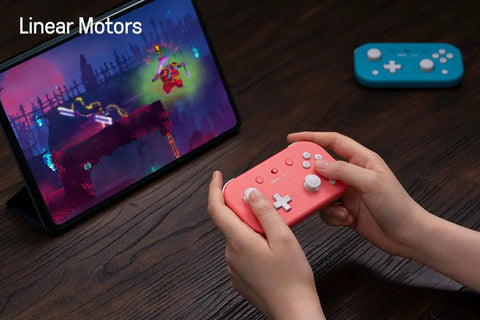 Hands holding Pocket Sized Lite 2 Bluetooth Controller With Motion Controls, Linear Vibration Motors, Dual Joysticks, pink gamepad