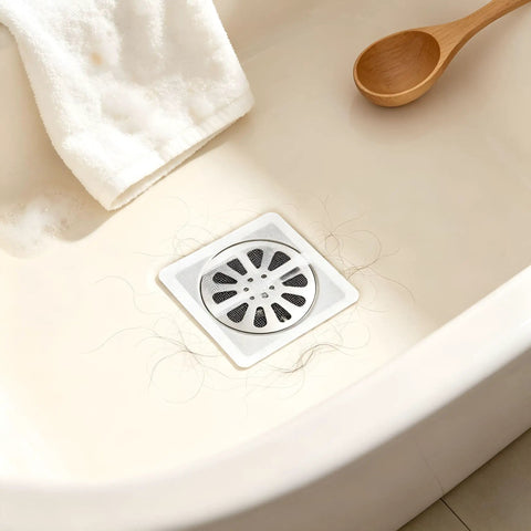 Hair Drain Stickers 100Pcs Disposable Self Adhesive on a shower floor with hair, featuring a dense mesh design.