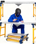 Built Different Multi Functional Heavy Duty Welding Table With Step Platform 1200 Lb Alloy Steel Workbench adjustable height with welder in action.