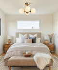 Antique Brass 4 Light Ceiling Light With Frosted Glass Globes, Mid Century Modern Chandelier in a cozy bedroom setting