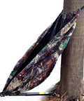 Camouflage Hammock Style Camping Chair That Hangs From Trees No Fuss Setup In Seconds Lightweight Portable Hunting Gear for outdoorsy hunters and camp lovers supports up to 330 pounds, shown attached to a tree.