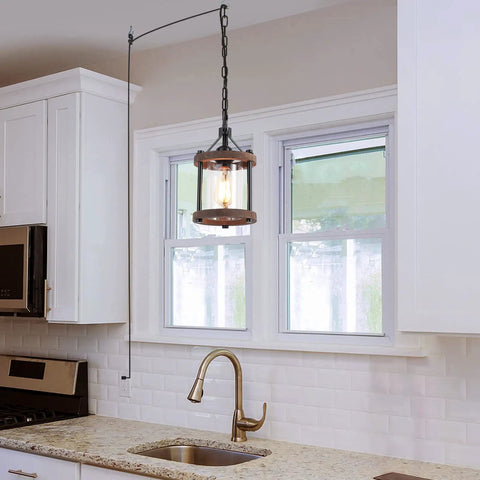 Cozy Farmhouse Style Plug In Pendant Light With Rustic Wood And Glass Cylinder over kitchen island, bronze metal finish