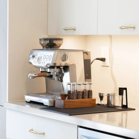 Espresso machine setup with Bottomless 54mm Portafilter With Walnut And Stainless For Breville Espresso Machines on kitchen counter.