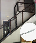 Indoor staircase with installed Three Sixteenth Inch Wire Rope Tensioner Kit With 100 Foot PVC Coated Steel Cable and zoomed turnbuckle.