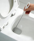 Flexible Drain Snake Cleaner Brush That Kicks Out Greasy Gunk Reusable Spiral Hair Removal Tool With Comfort Grip Handles For Sinks Showers And Bathtubs In White in use cleaning a toilet.