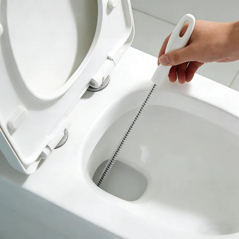Flexible Drain Snake Cleaner Brush That Kicks Out Greasy Gunk Reusable Spiral Hair Removal Tool With Comfort Grip Handles For Sinks Showers And Bathtubs In White in use cleaning a toilet.