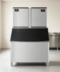 Heavy Duty Commercial Ice Maker Pumping Out Crisp Clear Cubes On The Fly With Stainless Steel Frame and black top in restaurant setting.