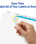 Close-up of hand applying label to 5 Tab Unpunched Dividers For Any Binding System With Easy Print And Apply Clear Label Strips