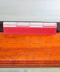 Close-up of Self Adhesive Acrylic Cabinet Hinges Flush Mount Butt Hinges For Cabinets And Drawers 100x42mm on a wooden surface