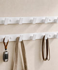 Heavy Duty Wall Mount Coat Rack Featuring Five Lock Down Hooks For All Your Everyday Essentials Like Hats Keys Wallets And Bath Towels Crafted From Corrosion Proof Aluminum In Crisp White Two Pack Bundle, mounted on wall.