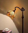 Tiffany Style Stained Glass Reading Floor Lamp With Antique Arched Tall Design 62 Inch Standing Lamp illuminating a warm ambient light