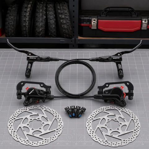 Complete Hydraulic Disc Brake Conversion Kit For Mountain Bikes With Two Ventilated Steel Rotors And Heavy Duty Metal Levers on a table.