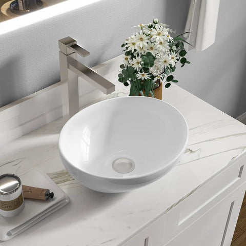 White rectangular ceramic countertop vessel sink 24 by 14 by 4.33 inches on marble vanity with modern faucet
