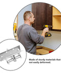 Person installing sturdy kitchen cabinet door hinges with cushioned soft close, focusing on cold rolled steel build.