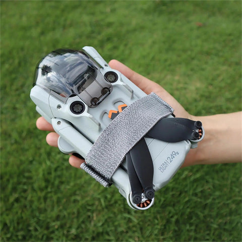 Hand holding drone secured with All Purpose Elastic Nylon Propeller Strap Kit No Fuss For Mini 5 Pro Mini 4K Mini 3 Mini 3 Pro Mini 4 Pro