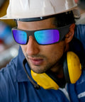 Worker wearing Six Pack Tinted Safety Glasses Protective Eyewear ANSI Z87.1 for Industrial Jobs, showing scratch resistant lenses and fit