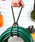 Heavy Duty Nylon Cord Strap Organizer Rope For Tailgate Parties And Campouts Holds Generator Cords Tight around green hose.