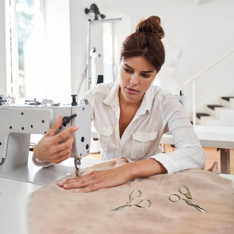 Woman sewing with machine, Stainless Steel Embroidery Scissors Set 2 Pcs 3.6 Inch Gold Tone Small Shears lying on table