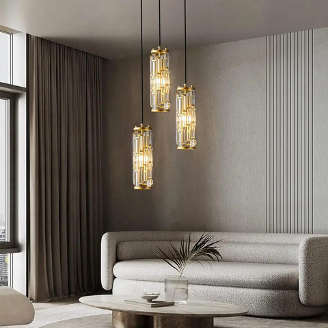 Gold 3 Light Modern Pendant Light Fixtures With Glam Crystal Chandeliers for kitchen, dining room, bedroom hanging above modern living room.