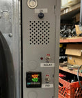 Control panel showing relay and PID display with adjustable knob, designed for electronic systems, located in a garage.