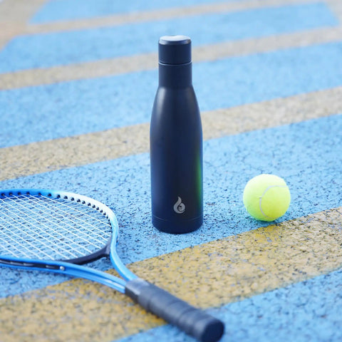 Boss Grade 17 Oz Insulated Thermal Water Bottle With Airtight Drip Proof Lid Double Wall Vacuum beside a tennis racquet and ball.