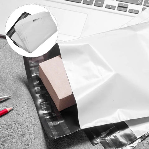 100 Pack White Poly Mailer Bags Thickened Lightweight Envelopes With Strong Adhesive Seal For Clothing Shipping And Small Business Mailers Leakproof Rainproof Quick Seal Design with package inside, shown on table