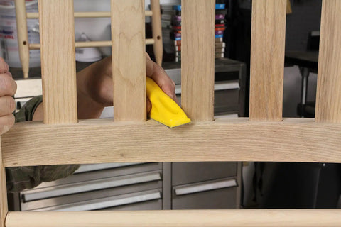 Person using MicroZip Sander Kit With Assorted Grit Sanding Sheets For 3.5 Inch By 1 Inch Hook And Loop Pad on wooden slats