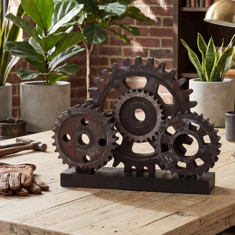 Novabright Vintage Copper Steampunk Gear Train Figurine For Desk Decor, rustic wooden cog wheel on a table with plants.