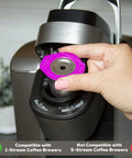 Inserting stainless steel reusable K-Cup with metal filter into Keurig brewer, compatible with 1-stream coffee brewers.