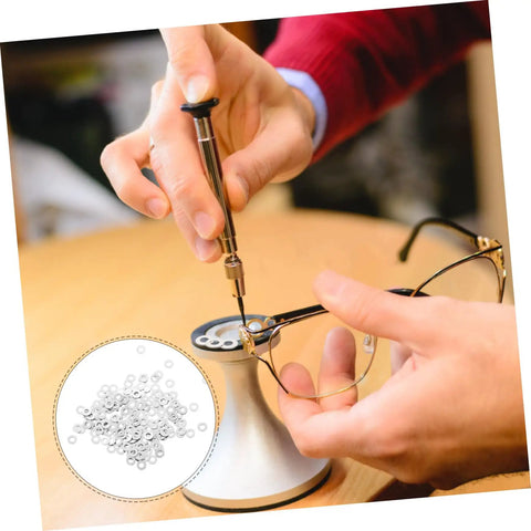 200 Piece Rimless Eyeglass Frame Repair Washers For Quick Repairs Sturdy Metal Flat Washers installation close-up, tool in use