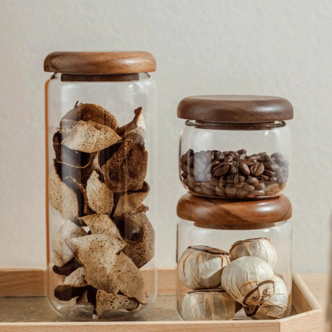 Four Piece Glass Storage Jars With Airtight Wooden Lids Wide Mouth Canister Set For Coffee Beans Sugar Tea Kitchen Pantry Upgrade Built Different Design Keeps Goods Fresh As Heck Super Easy Cleanup with dried fruits and coffee beans.