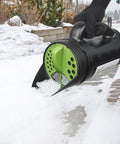 Handheld Spreader For Lawn And Garden With 80 Oz Capacity Adjustable Opening For Seed Fertilizer Salt Ice Melt in use on snow