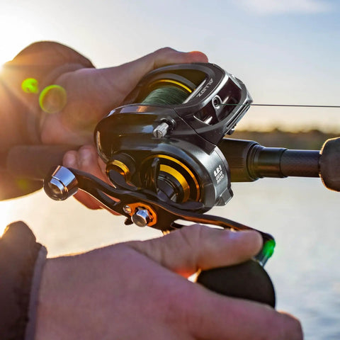 Hands holding Alijoz 300 Baitcaster Fishing Reel With Aluminum Frame, 33 Lb Max Drag, 8.1 To 1 Gear Ratio on fishing rod