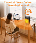 Compact Indoor Space Heater With Digital Display And Remote on desk, showing heat flow and 24H timer in home office setup