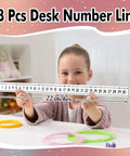Child holding 48 Piece Laminated Number Line Set 0 To 30 For Student Desks Classroom Math Decor Boho Style Counting Practice Strips