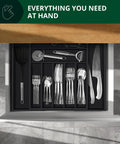 Overhead view of bamboo kitchen drawer with black utensil tray and cutlery in 9 grooved slots
